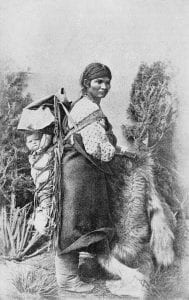 Navajo mother and her baby in a traditional papoose.