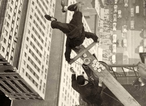 Shipwreck Kelly does headstand on wooden plank, 54 stories in the air.