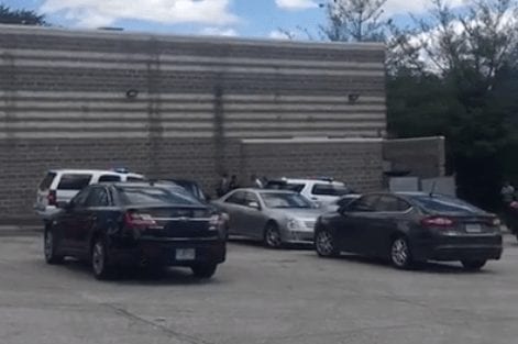 Ferguson detective vehicles in parking lot with Darren Seals