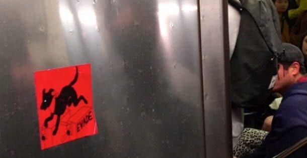 Sticker of El Negro Matapacos in NYC subway.