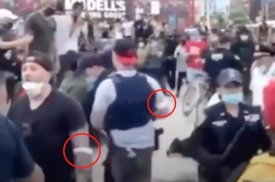 Undercover cops in BLM protests with armband.