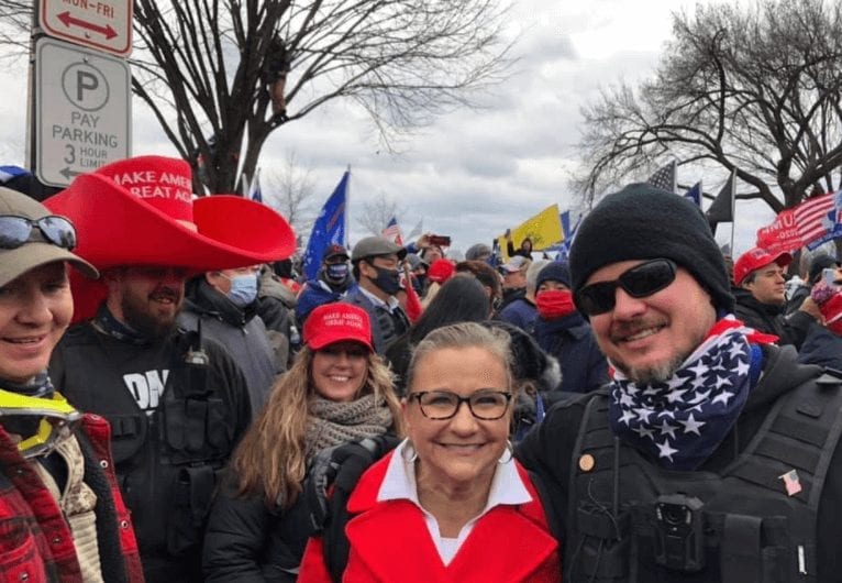 Amanda Chase poses with pro-Trump demonstrators at Capitol on Jan 6. 