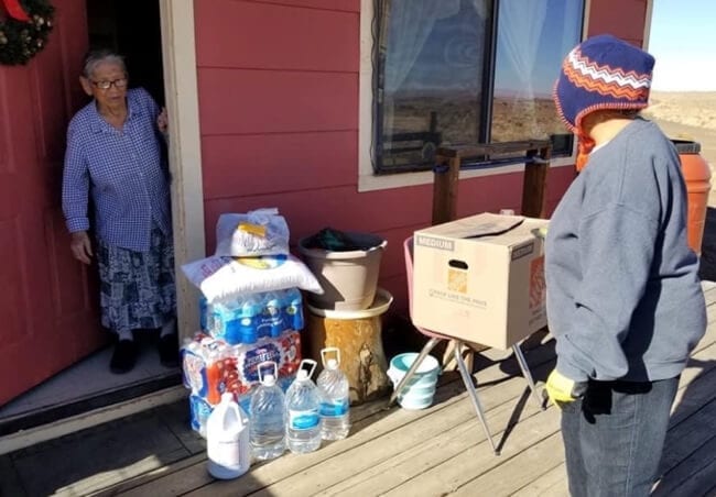 Elderly Navajo woman receives coronavirus care package.