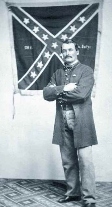 Marshall Sherman with the Confederate VA battle flag he captured