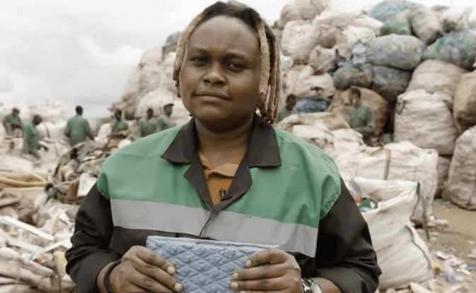 Nzambi Matee holds a plastic brick