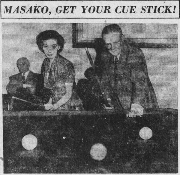 Cochran and Masako pose over a billiard table